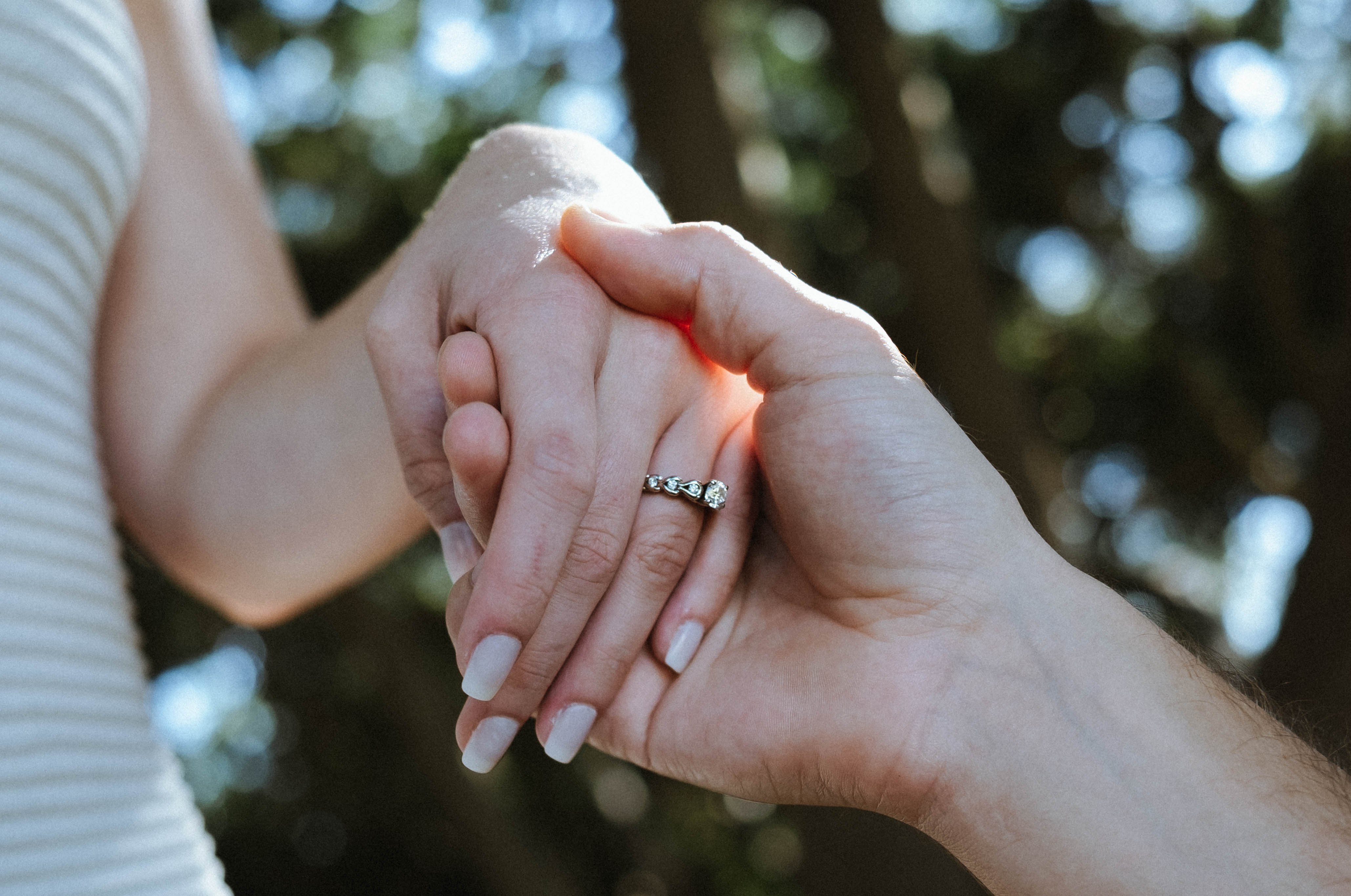 Close-up of hands holding with engagement ring
